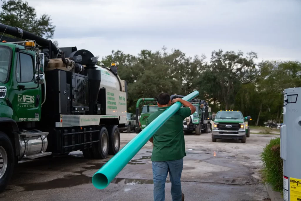 meeks employee carrying teal pipe