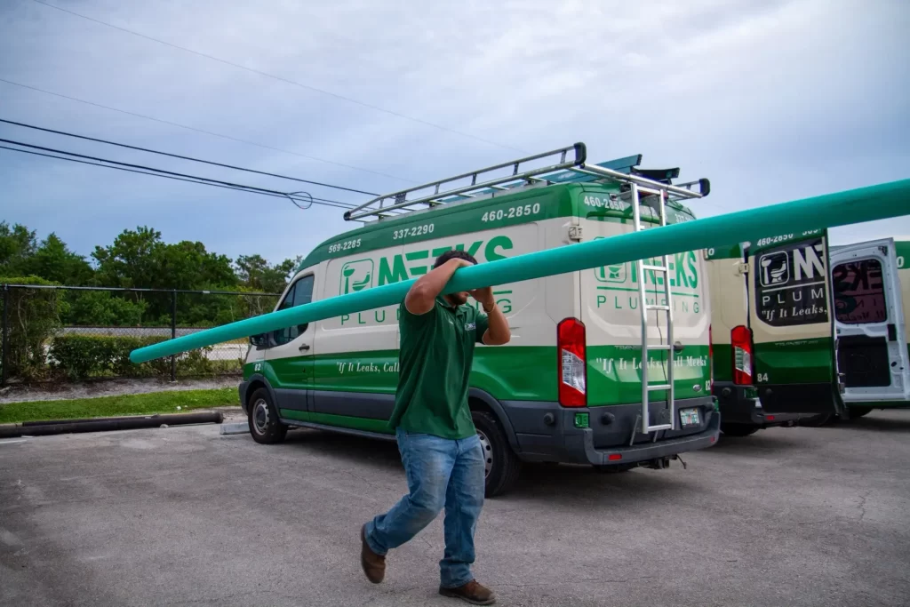 meeks employee carrying teal pipe